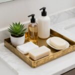 Elegant bathroom vanity tray with organized toiletries and decorative items